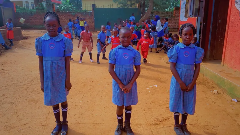 Pupils gathered outdoors in their school uniforms.