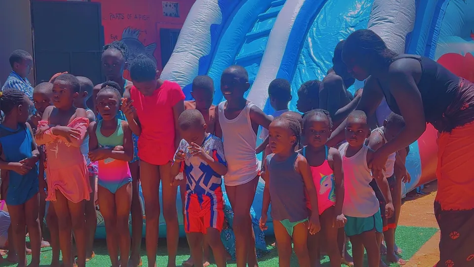 Children gathered beside an inflatable play structure.